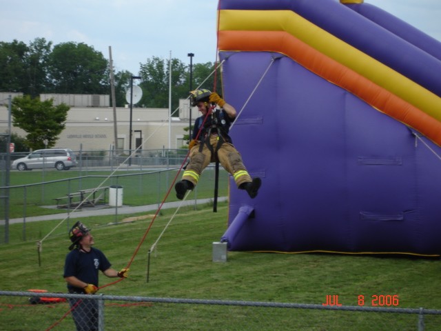 Uwchlan Township Day 07-08-2006.
Chief Engineer Norwood holds the line for FF Esterlis.